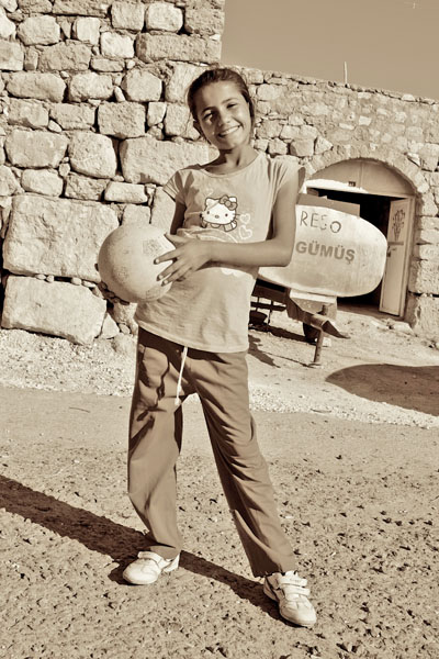 A Smiling Girl Is Holding A Ball